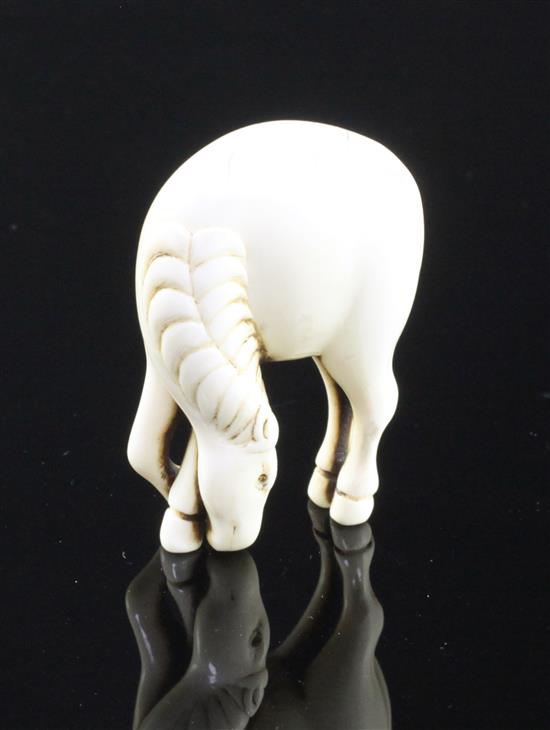 A Japanese stag antler netsuke of a horse, 18th/19th century, 4.9cm